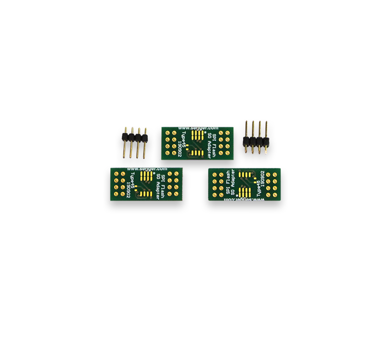 SEGGER (Q)SPI Flash Evaluator Adapter Board Pack for SO-8, SO-8W, SO-16 Three green circuit boards are displayed, each featuring multiple gold-plated pins and labeled as "ISP Adapter." There are also two sets of black connector pins positioned near the boards. The image highlights electronic components typically used for programming or connecting devices.