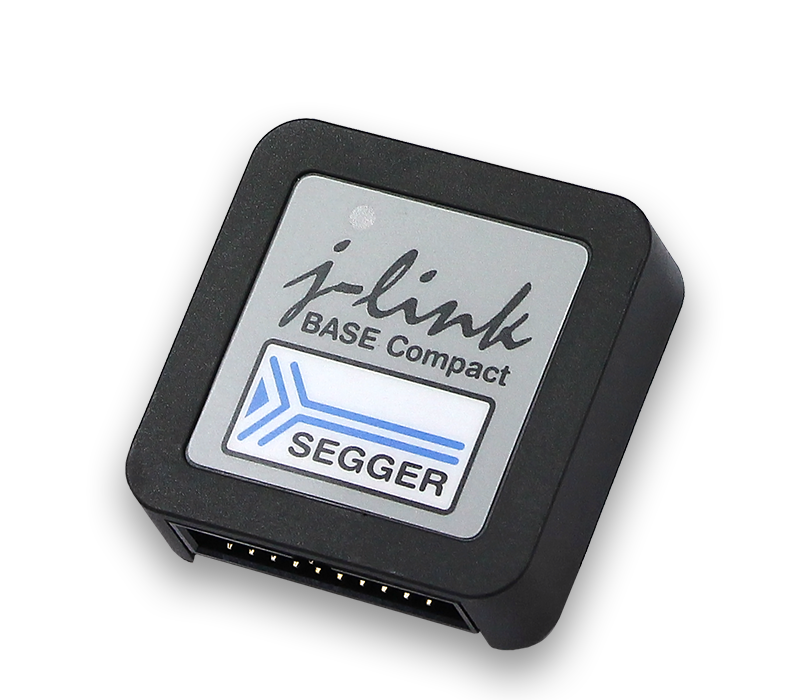 J-Link BASE Compact A compact debugging tool labeled "j-link BASE Compact" with the SEGGER logo. It has a rectangular shape with a black casing and a gray top surface featuring the brand name and logo. This device is designed for programming and debugging embedded systems.